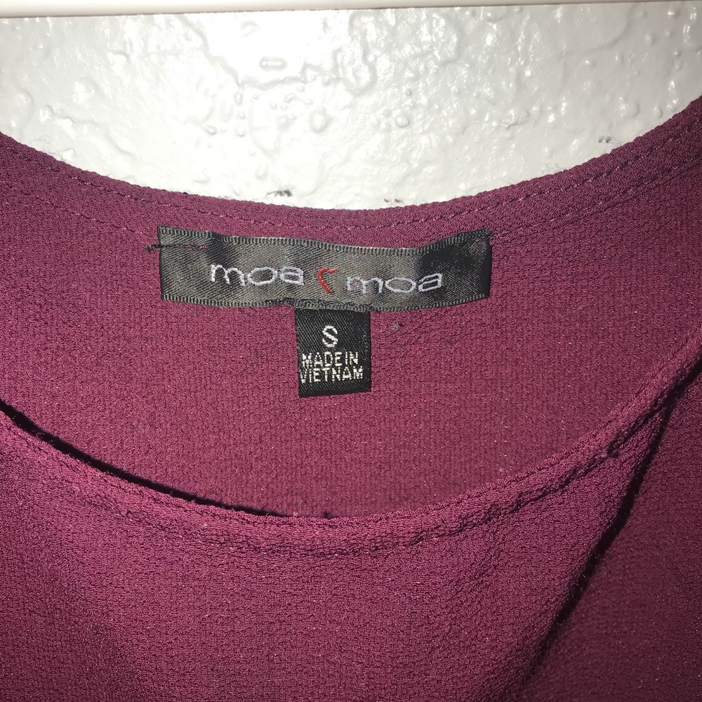 Deep plum/ maroon top with ruffled sleeve detail.
